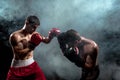 Two professional boxer boxing on black smoky background,