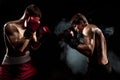 Two professional boxer boxing on black smoky background,