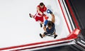 Two professional boxers boxing on white background on the ring, action, top view