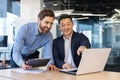 Professional businessmen collaborating in an office environment using laptop Royalty Free Stock Photo