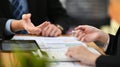 Two professional businesspeople checking, analyzing financial reports together at office