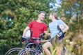 Two Professional Cycling Athletes Standing Together Outdoors wit