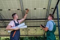 Two professional electrician checking installation at solar panels Royalty Free Stock Photo