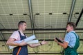 Two professional electrician checking installation solar panels Royalty Free Stock Photo