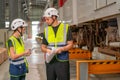 Two professional engineer or technician worker discuss about work and stand near the train in workplace area Royalty Free Stock Photo