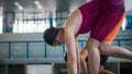 Two female swimmers taking the start position and jumping in a pool Royalty Free Stock Photo