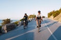 Two professional male cyclists riding their racing bicycles in the morning together Royalty Free Stock Photo