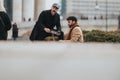 Two professional men in stylish attire walking together outside an office building, symbolizing partnership and Royalty Free Stock Photo