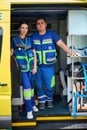 Two professional paramedics in ambulance interior posing at camera Royalty Free Stock Photo