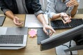 Two professional programmer cooperating and working on web site project in a software developing on desktop computer at company, Royalty Free Stock Photo