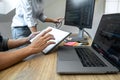 Two professional programmer cooperating and working on web site project in a software developing on desktop computer at company, Royalty Free Stock Photo