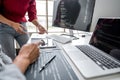 Two professional programmer cooperating and working on web site project in a software developing on desktop computer at company, Royalty Free Stock Photo
