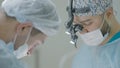 Two professional surgeons on operation. Action. Surgeons calmly and intently perform operation with anesthesia. Surgeons Royalty Free Stock Photo