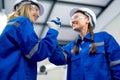 Two professional technician or engineer woman workers hold and grab hands together to express join and work with teamwork in