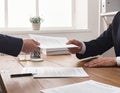 Business Handshake and Document Exchange in Office Setting Royalty Free Stock Photo