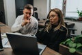 Business colleagues discuss a project on a laptop in a modern bright office Royalty Free Stock Photo