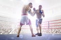 Two professionl boxers are fighting on arena Royalty Free Stock Photo