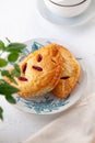 Two puff buns with raspberries on a vintage plate on a white background close-up