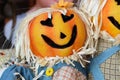 two pumpkin head scarecrow on display next to a babys portrait Royalty Free Stock Photo