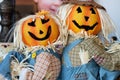 two pumpkin head scarecrow on display next to a babys portrait Royalty Free Stock Photo