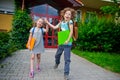 Two pupils of elementary school, boy and girl, on a schoolyard. Royalty Free Stock Photo