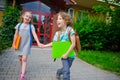 Two pupils of elementary school, boy and girl, on a schoolyard. Royalty Free Stock Photo