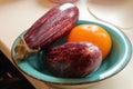 Two purple eggplants and a yellow tomato Royalty Free Stock Photo
