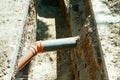 Two pvc sewer pipe connected underground in the trench on the street. Royalty Free Stock Photo