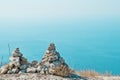 Two pyramids of stones against the blue sea Royalty Free Stock Photo