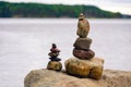 Two pyramids of stones on the lake. Ladoga skerries. Royalty Free Stock Photo