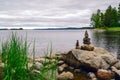 Two pyramids of stones on the lake. Ladoga skerries. Royalty Free Stock Photo