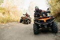 Two quad bike riders travels in forest, front view Royalty Free Stock Photo