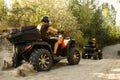 Two quad bike riders travels in forest, front view Royalty Free Stock Photo