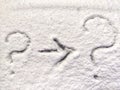 Two question marks and arrow written in the snow. The cold frosty texture of the snow and the question mark. Background Royalty Free Stock Photo