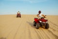 Two racers coming down from the dunes on atv Royalty Free Stock Photo