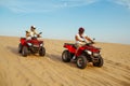 Two racers coming down from the dunes on atv Royalty Free Stock Photo