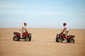 Two racers in helmets stand face to face on atvs Royalty Free Stock Photo