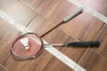 Two rackets and shuttlecocks on the badminton court floor Royalty Free Stock Photo