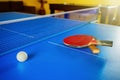 Two rackets for a table tennis or Ping-Pong and a ball on a blue table Royalty Free Stock Photo