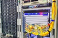 Two racks with servers are located in the server room of the data center. The yellow optical cables are connected to the central Royalty Free Stock Photo