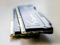 Two RAM Kingston Fury memory modules on a table. DIMM DDR 4 Kingston HyperX Fury on a gray surface. Side view