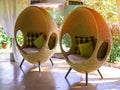 Two rattan egg chairs with pillows Royalty Free Stock Photo