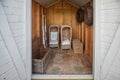 Two rattan garden chairs and rattan baskets stowed in the shed