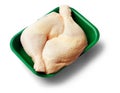 Two raw chicken legs in a green tray over white background Royalty Free Stock Photo