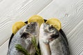 Two raw dorado fish close-up on a platter