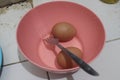 Two raw eggs are in a pink bowl Royalty Free Stock Photo