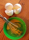 Raw eggs, shells and whisk