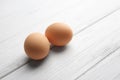 Two raw eggs on wooden background Royalty Free Stock Photo