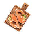 Two raw fresh salmon steaks on a wooden cutting board isolated on a white background. Top view, flat lay Royalty Free Stock Photo