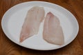 Two raw haddock fillets on a white plate Royalty Free Stock Photo